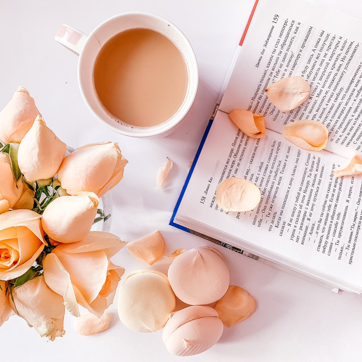 White Ceramic Mug Beside A Book